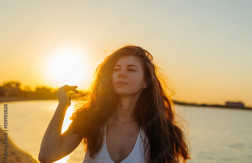 Portrait of a woman with long hair at sunset close-up Portrait of a woman with long hair at sunset close-up