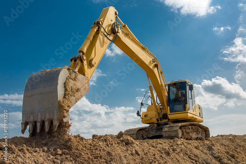 excavator blue sky heavy machine construction site photo