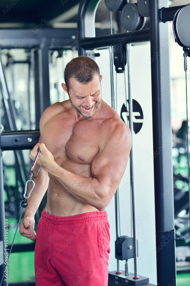 Man at the gym. Man makes exercises with barbell Man at the gym. Man makes exercises with barbell