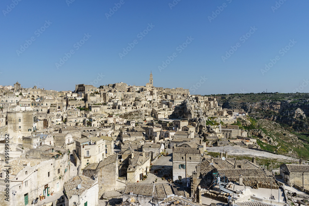 beauty of ancient ghost town of Matera (Sassi di Matera) in bright sun shine summer with blue sky, south Italy