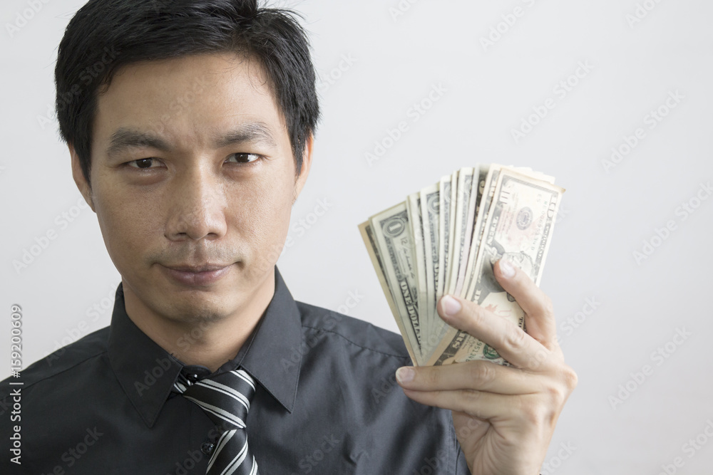 Portrait of Asian businessman holding dollar banknote Portrait of Asian businessman holding dollar banknote