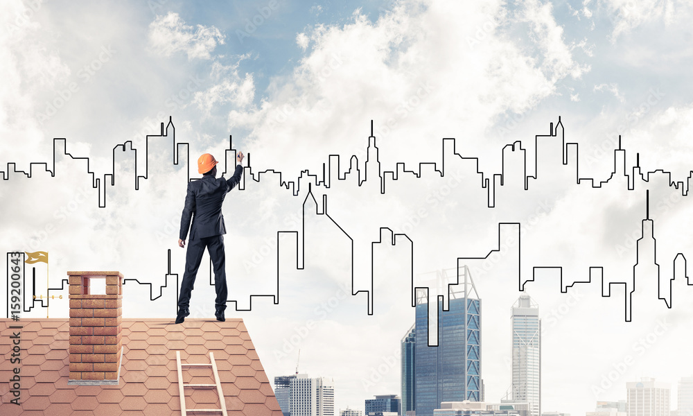 Man architect draw silhouette of modern city on blue sky. Mixed Man architect draw silhouette of modern city on blue sky. Mixed