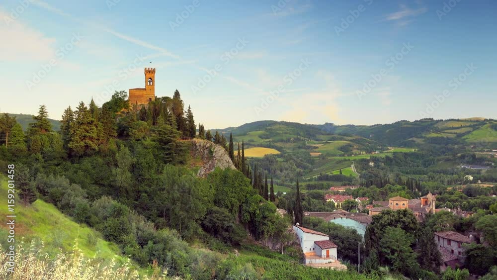 timelapse of landscape of Emilia Romagna with clock tower on a cliff overlooking the medieval village of Brisighella in Italy timelapse of landscape of Emilia Romagna with clock tower on a cliff overlooking the medieval village of Brisighella in Italy