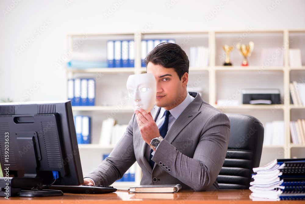 Businessman with mask in office hypocrisy concept Businessman with mask in office hypocrisy concept