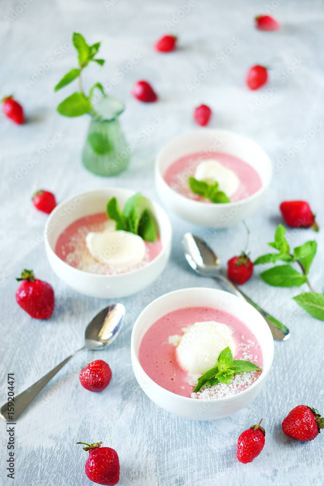 Cold creamy strawberry soup with a scoop of ice cream and mint Cold creamy strawberry soup with a scoop of ice cream and mint