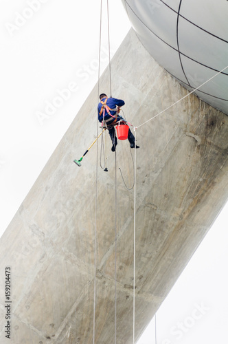 Cleaning windows service on high rise building. it is dangerous work for Professional worker.