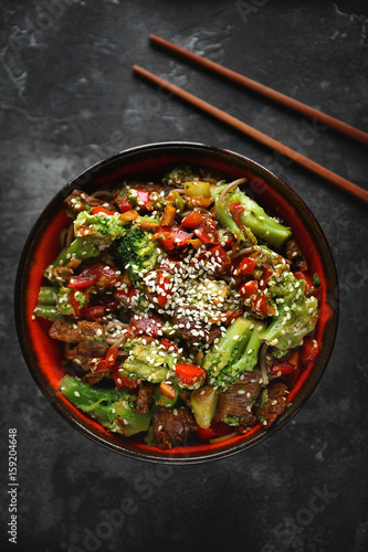 Noodles with vegetables and meat on a dark background, Asian food, Top view, Selective focus