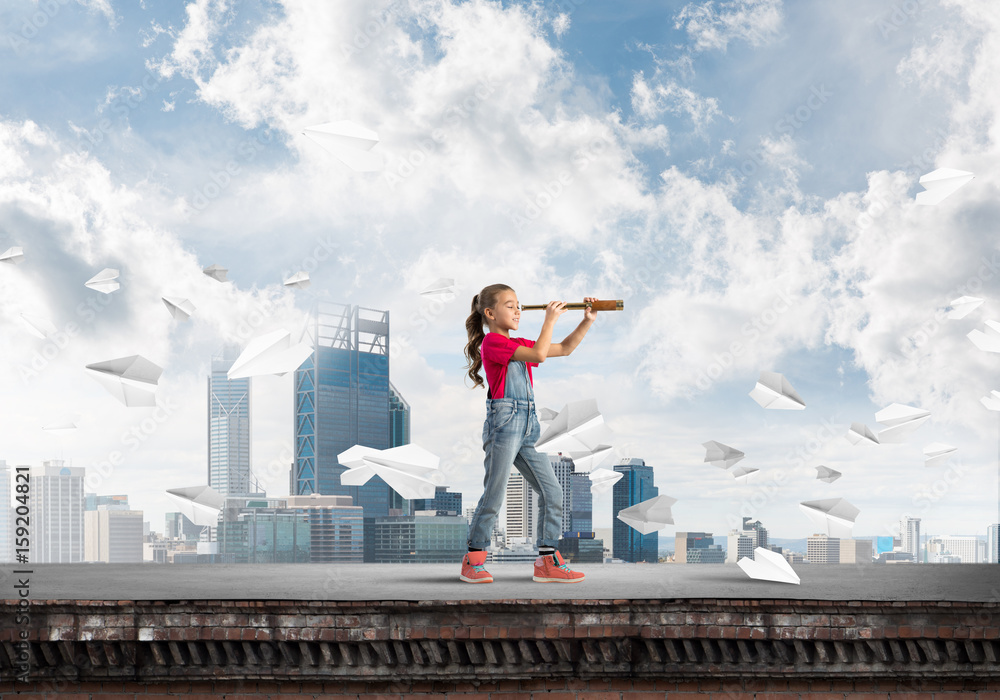 Concept of careless happy childhood with girl exploring this world