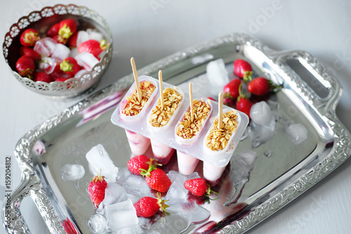 Frozen yoghurt popsicles with strawberries