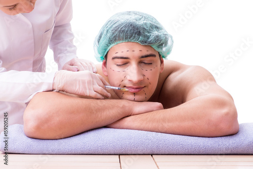 Handsome man in spa massage concept