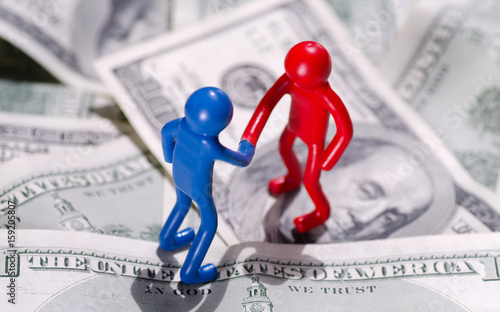 Fotografie Symbol Two People Shake Hands On Money