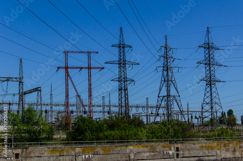 High voltage power lines and towers against sky