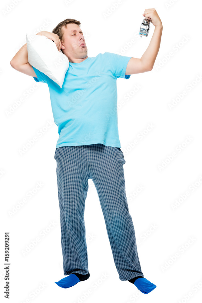 Sleepy man in pajamas with pillow and alarm clock on white background Sleepy man in pajamas with pillow and alarm clock on white background