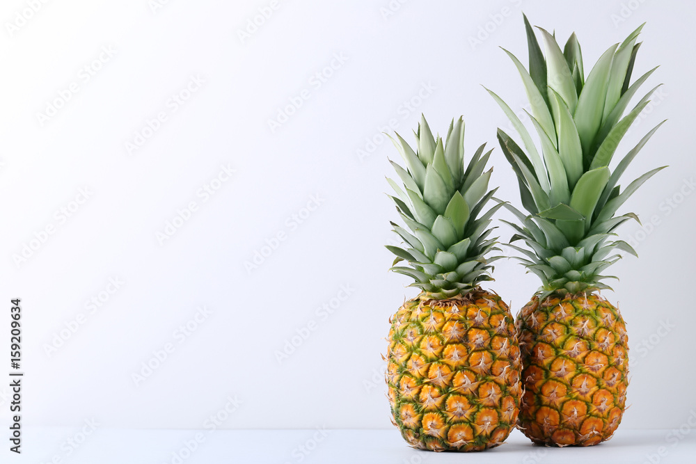 Fototapeta premium Ripe pineapples on grey background