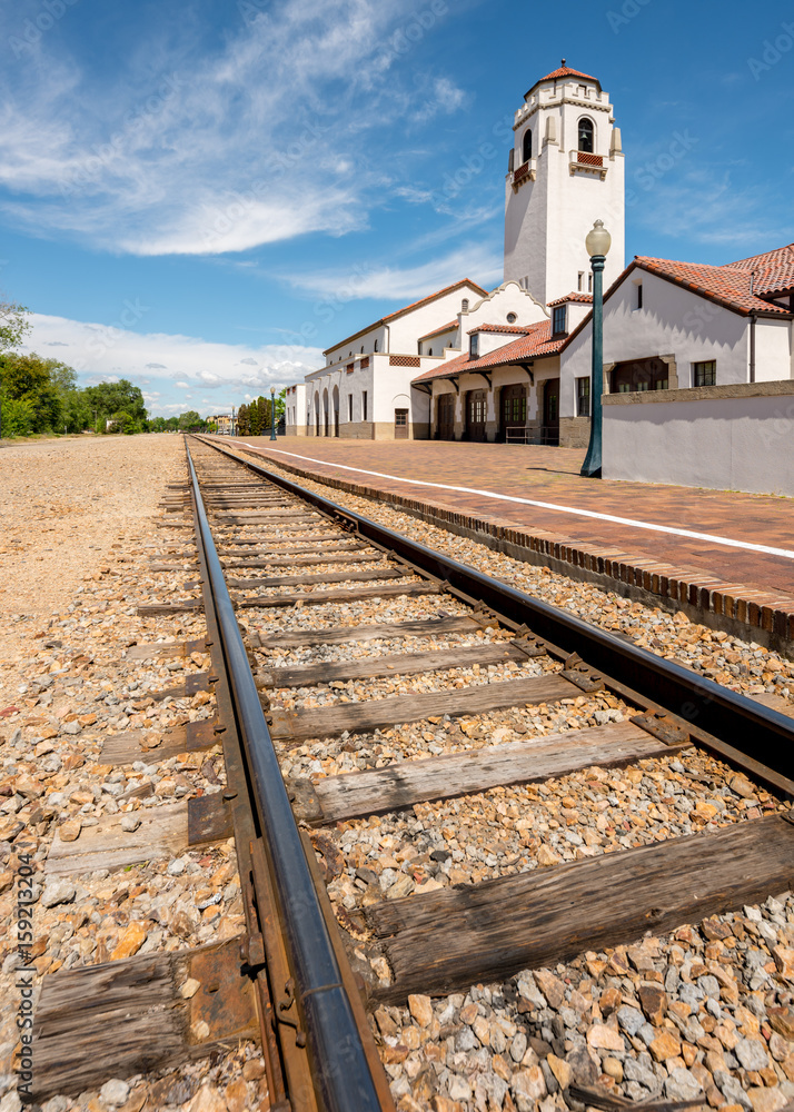 railroad tracks lead past a local train depot