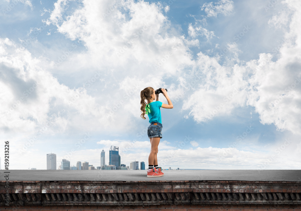 Concept of careless happy childhood with girl of school age looking in future Concept of careless happy childhood with girl of school age looking in future