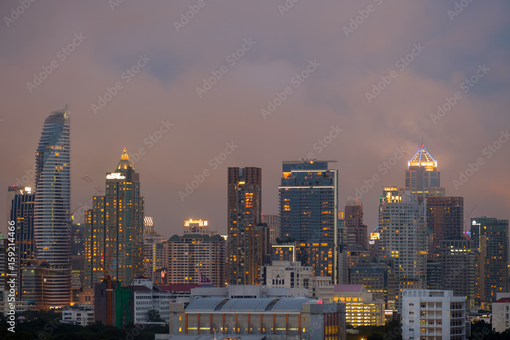 City / City and rain cloud at twilight.