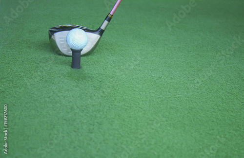 golf ball on tee with driver club, in front of driver, driving range