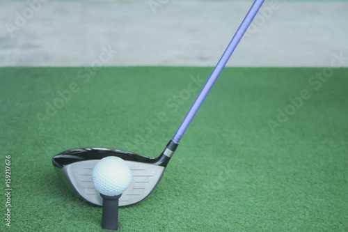golf ball on tee with driver club, in front of driver, driving range