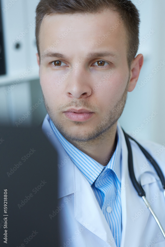 Closeup portrait of a young male doctor looking at x-ray. Closeup portrait of a young male doctor looking at x-ray.