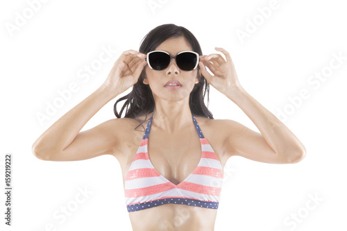 Beautiful woman wears swimsuit and sunglasses