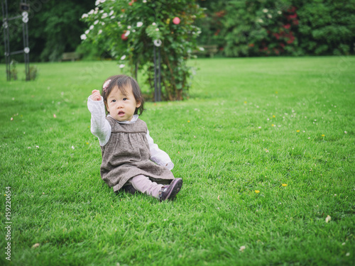 baby girl playing in summer garden