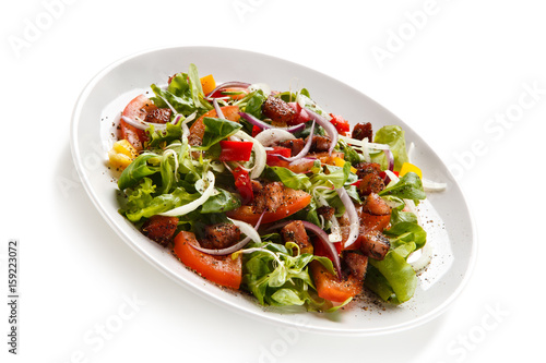 Salad with smoked ham on white background 