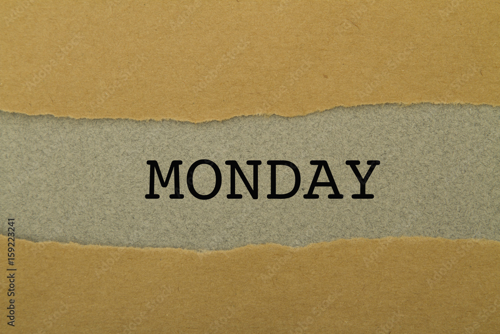 Monday word written under torn paper. Monday word written under torn paper.