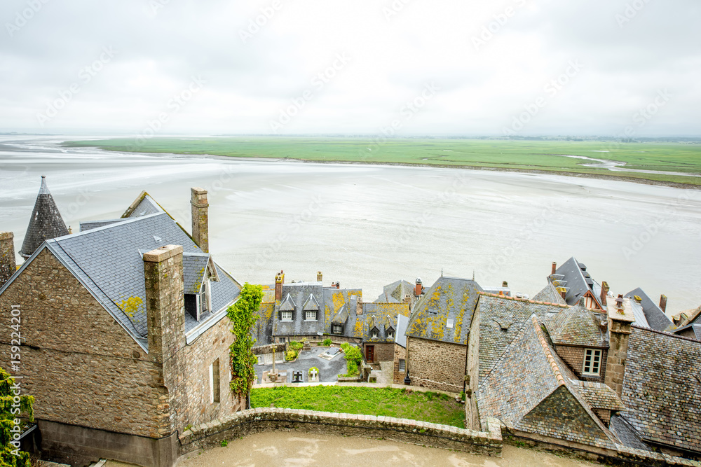 View from the ambasady on the old town and the ocean in Mont Saint Michel in France - obrazy, fototapety, plakaty 