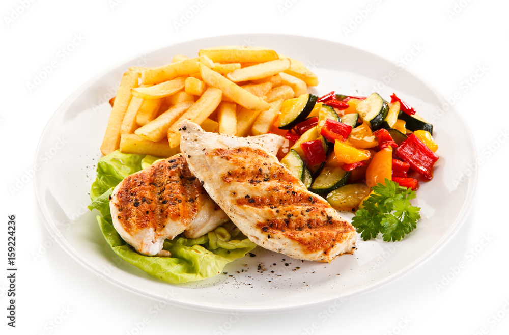 Grilled chicken fillet with french fries on white background Grilled chicken fillet with french fries on white background