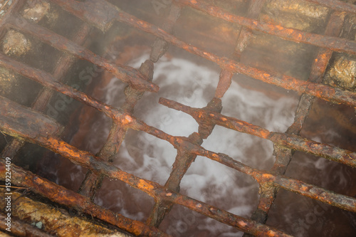 Rusty corroded grating over  thermal spring in Loutra Edipsou photo