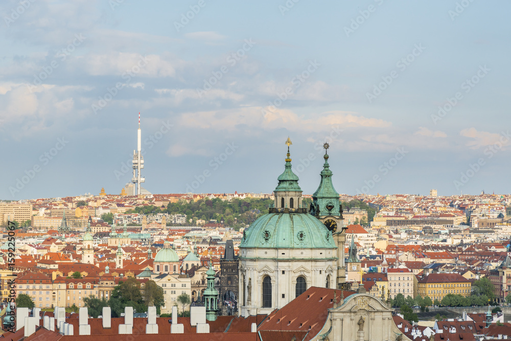 Aerial view of the Prague city with St Nicholas Bell Tower in the foreground
