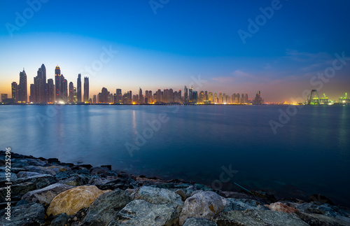 The beauty panorama of skyscrapers in Dubai from promenade at dusk.