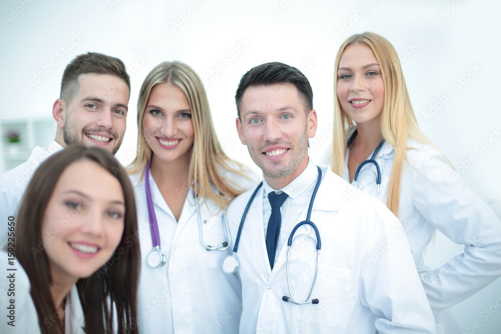 Smiling team of doctors at hospital making selfie. Smiling team of doctors at hospital making selfie.