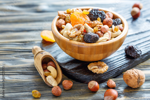 Nuts and dried fruit in a wooden bowl.