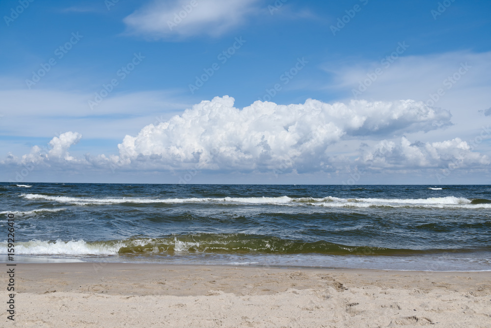 Baltic Sea - water waves. Beautiful blue sky with cumulous clouds. Baltic Sea - water waves. Beautiful blue sky with cumulous clouds.