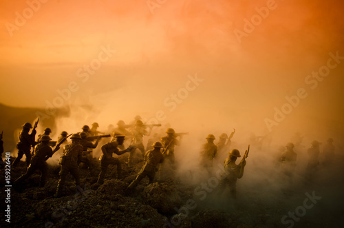 War Concept. Military silhouettes fighting scene on war fog sky background, World War Soldiers Silhouettes Below Cloudy Skyline At night. Attack scene. Armored vehicles. Tanks battle