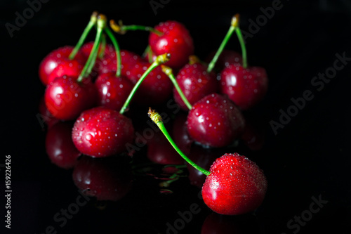 Group dew-covered cherries with reflection