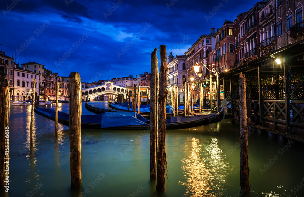 Panoramic view of Rialto bridge and Garnd Canal at night in Venice, Italy