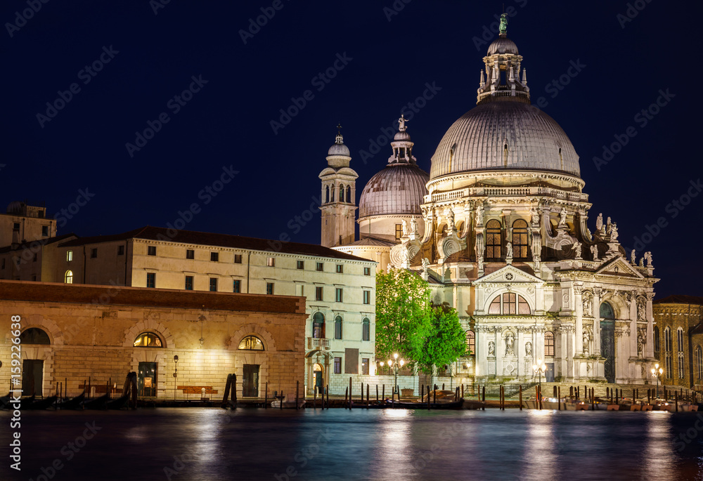 Ornate facade of the Santa Maria della Salute Church, Venice, illuminated at night, built by the Ventians to offer thanks for surviving the Plague  nocwenecjaarchitekturapieknypięknyblekitblekitnybłęk