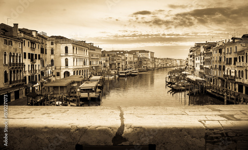 Vintage and panoramic view on famous Grand Canal among historic houses in Venice, Italy at sunrise. Picture took from the Rialto bridge.