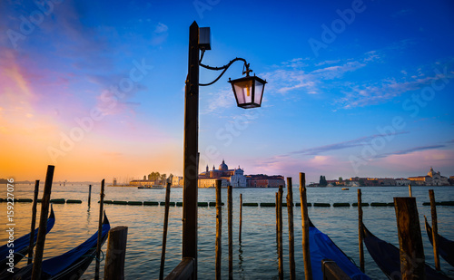 Street lamp and Gondola boats in front of Church of San Giorgio Maggiore, Venice, Italy at sunrise