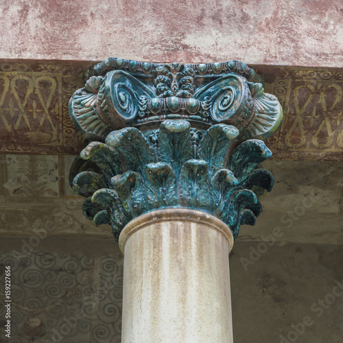 Detail of an ancient column with capital, roman architecture