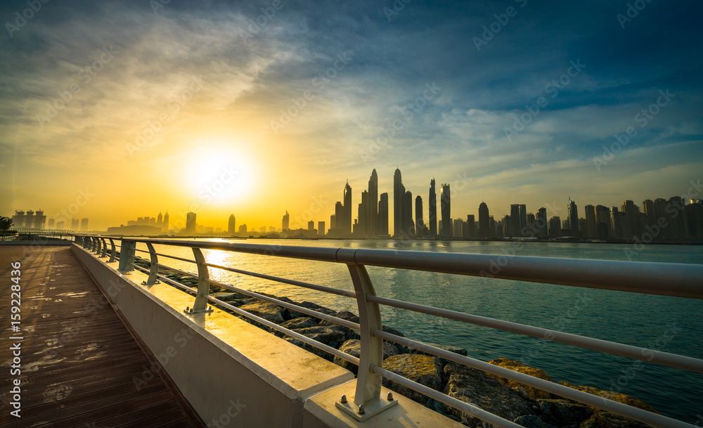 The beauty panorama of skyscrapers in Dubai from promenade at sunrise. UAE