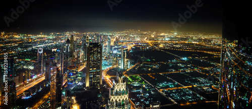Dubai Downtown Night Panorama From Top with blurry reflection on the right site.UAE