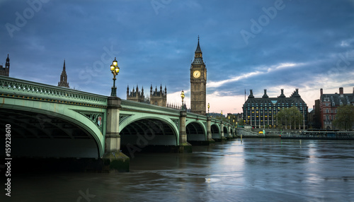 Big Ben and Westminster bridge in London at dusk. © offcaania