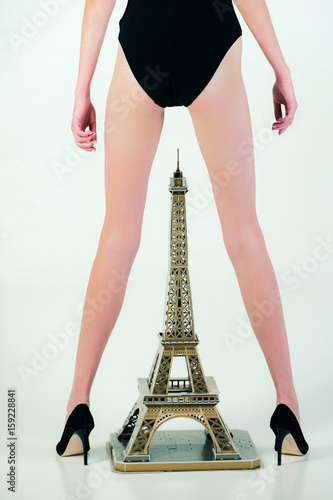 slim legs of woman in black pants above eiffel tower © Volodymyr