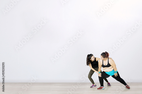 Overweight woman with her personal trainer