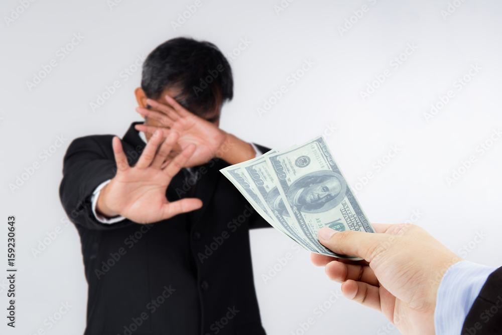 Businessman refuses to receive money - no bribery and corruption concept Businessman refuses to receive money - no bribery and corruption concept