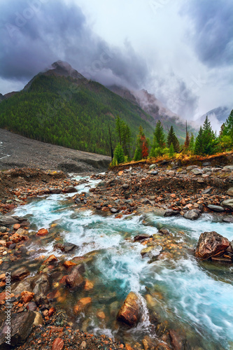 Mountain landscape with the river. Rainy gloomy weather